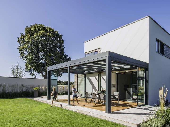 Aus einem Guss: Das kubische Eigenheim wurde um ein Glashaus mit Flachdach als Wind- und Wetterschutz erweitert.     Bildnachweis: Solarlux GmbH